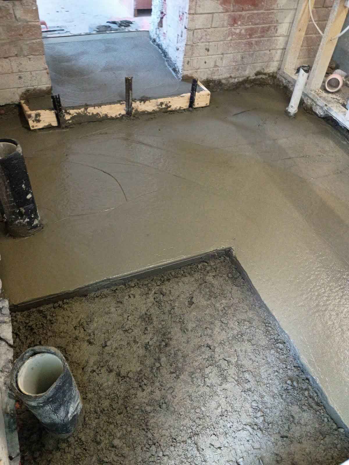 Freshly poured concrete floor inside a renovation